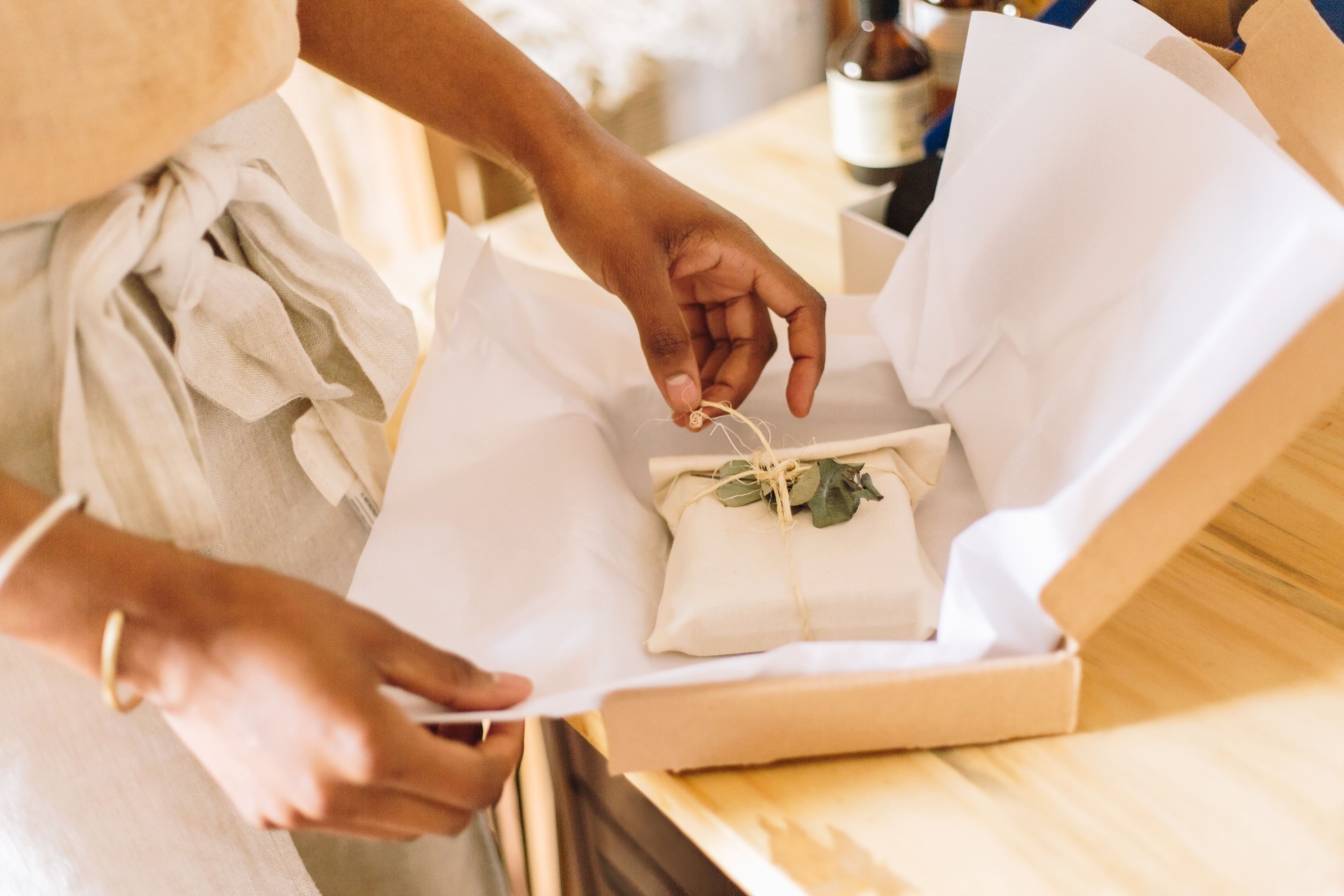 Woman jewelry business owner packing order